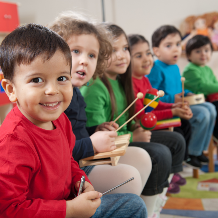 Small children playing musical instruments 